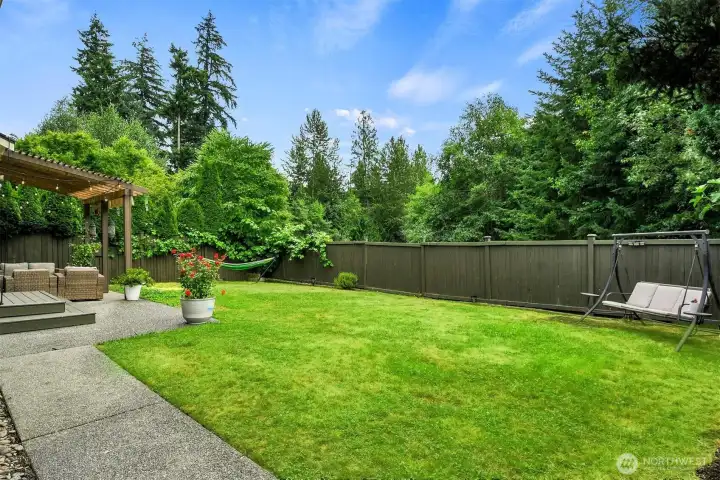 Private, fully fenced backyard featuring a spacious entertainment patio with pergola, lush lawn, mature landscaping, and plenty of room to relax, garden, or play. Private, fully fenced backyard featuring a spacious entertainment patio with pergola, lush lawn, mature landscaping, and plenty of room to relax, garden, or play.