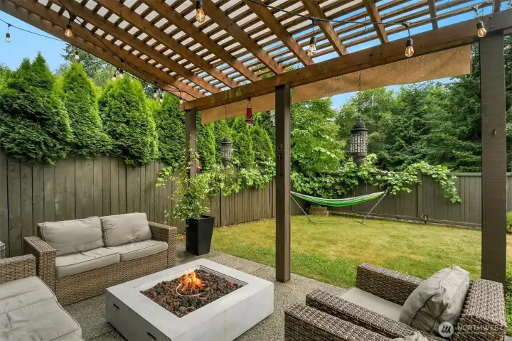 Relax year round beneath the covered pergola patio, an inviting outdoor living space perfect for entertaining or unwinding by the fire table. Relax year round beneath the covered pergola patio, an inviting outdoor living space perfect for entertaining or unwinding by the fire table.
