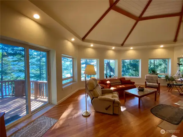 Glass doors provide access to comfortable deck. Morning coffee on the deck?