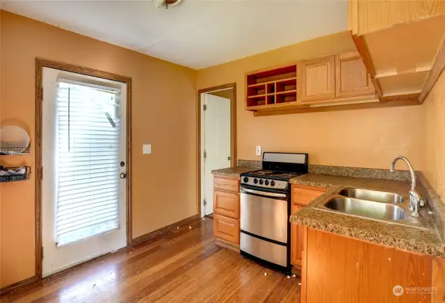 View of the entry into the kitchen and entry to the living space.