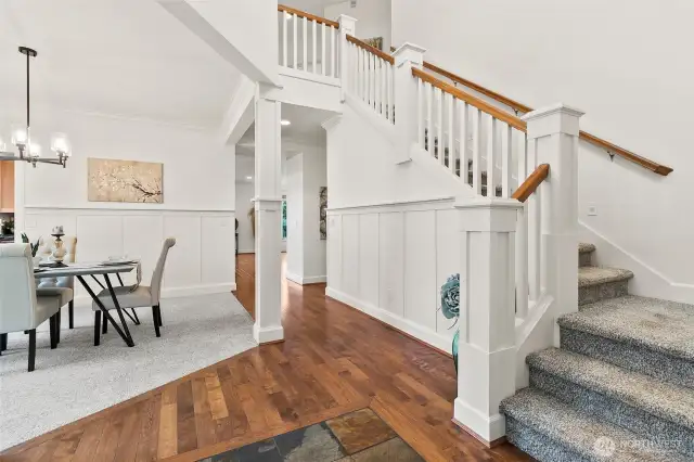 Inside the front door there is an open and bright entry with the stairs leading upstairs and the formal dining room.