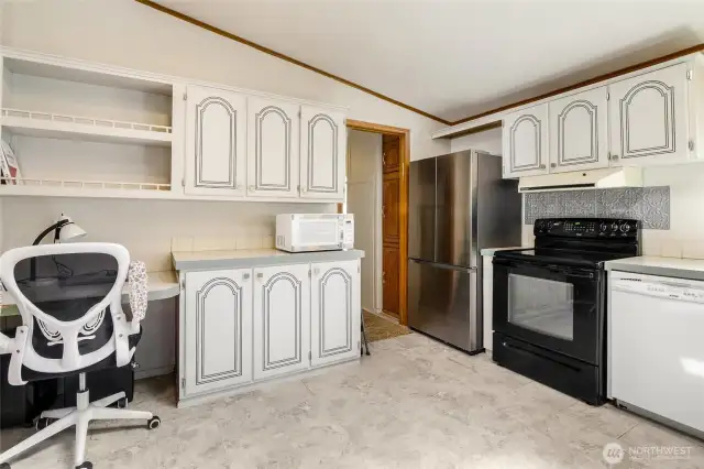 How handy to have office space in the kitchen for writing up your grocery list and paying bills. The doorway leads to the laundry room and back door.