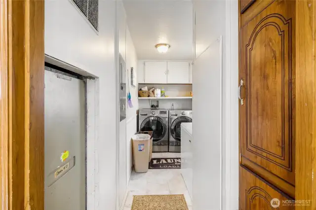 With the kitchen behind you and a pantry to your right, come on down this hall to the laundry/utility room and back door.