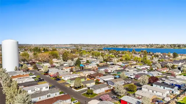 Home sits in a quiet neighborhood. See minty green home in middle, partway up from the bottom of the photo. Close to the lake and parks.