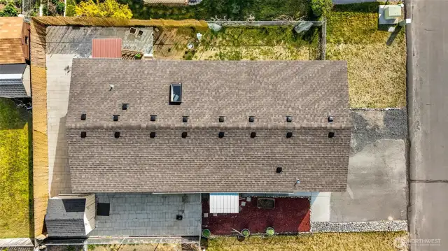 Simple yard maintenance for the busy home owner. Just a little grass in top right and upper side of photo. The rest is full of pavers, bark, and repurposed rock by the driveway.