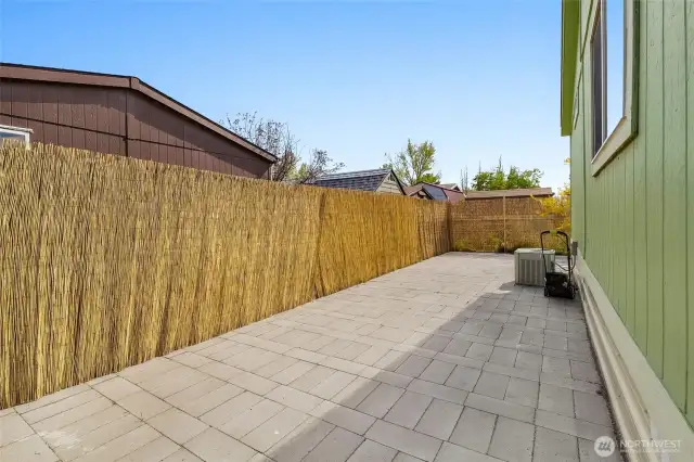 Bamboo privacy fence attached to six foot fence.  All pavers in the backyard.