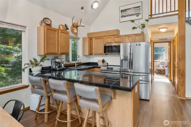 This kitchen has stainless steel appliances, granite countertops with cabinets that encourage display high above.  You could showcase those collectables you have stored in boxes right here in this space.