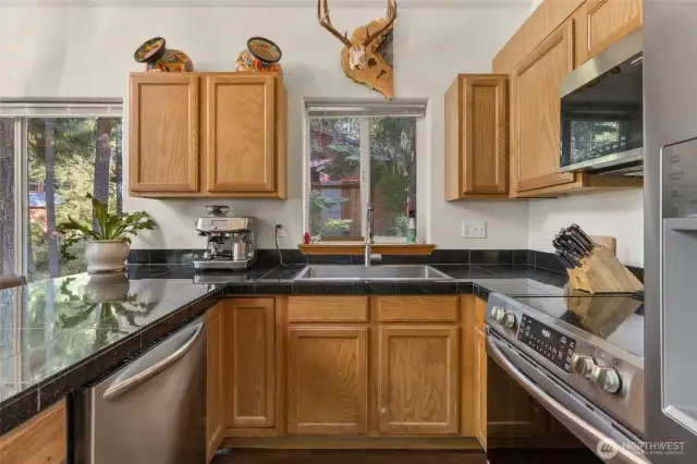 Dishwasher, oven/stove combo, microwave and large frig/freezer combo complete the appliances in this kitchen.