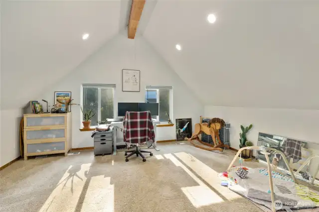 Natural light continues even in the loft with large windows on the back wall.