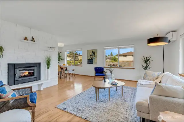 Spacious living room with energy efficient wood fireplace insert.