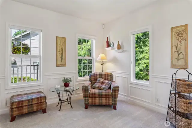 First of two living spaces on the main floor.  This smaller living area is ideal for a quiet moment to read....or, with the addition of a wall and French doors, it could be a main floor office.