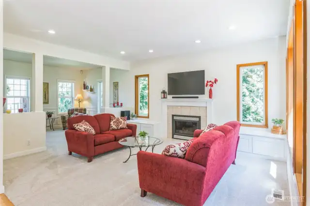 Light filled living room with gas fireplace.