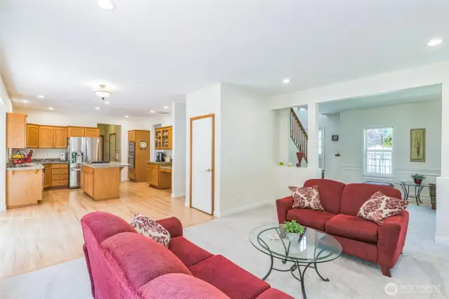 Walk-in pantry is just beyond kitchen, as well as a powder room for guests.  A separate laundry room and access to the garage rounds out the space.