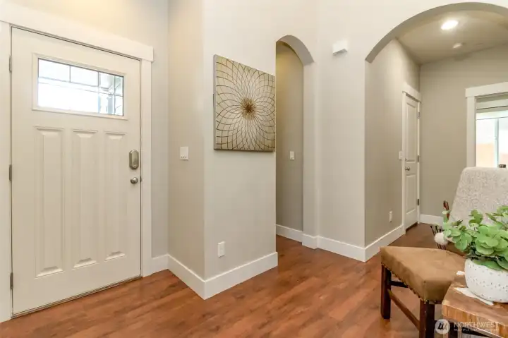 Interior entry with half bath off hallway.