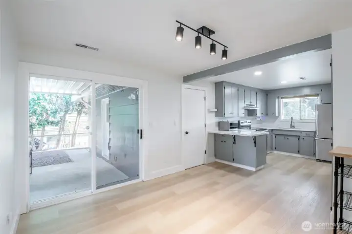 Dining room just off kitchen (open flow from kitchen to dining). Sliding glass door on the right of this photo to covered concred patio & back yard.