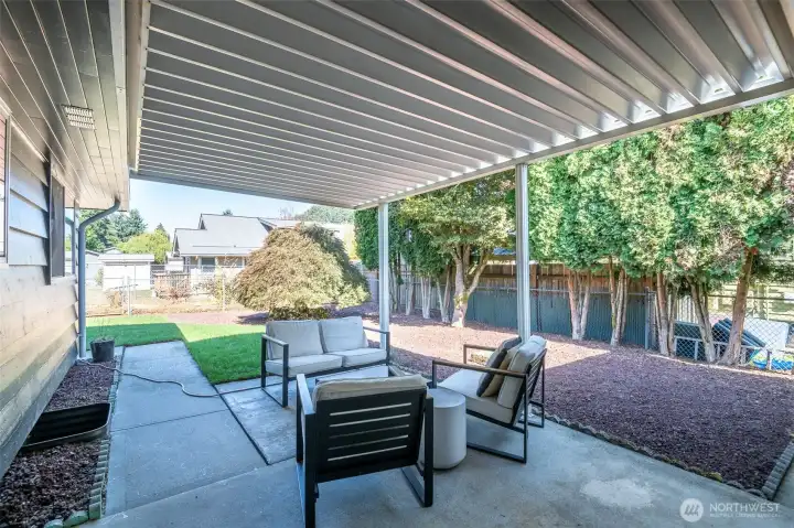 Covered patio off Large Kitchen, to easily access patio & backyard. Fully Fenced (front, back, sides).