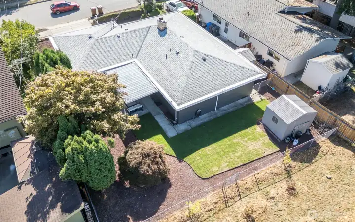 Aerial Photo from NE to SW.  Fully Fenced (front, back, sides).  Storage Sheds Convey.  Covered patio off Large Kitchen, to easily access patio & back yard. Fenced dog run on West Side of Property.