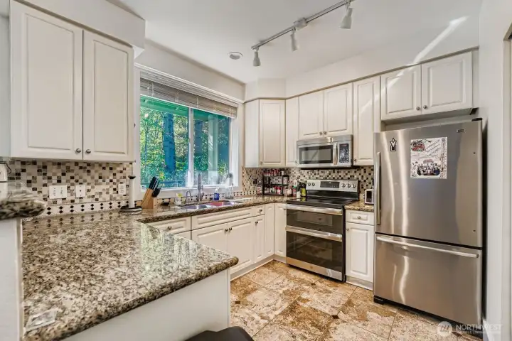 Stylish kitchen with granite counters and modern finishes.