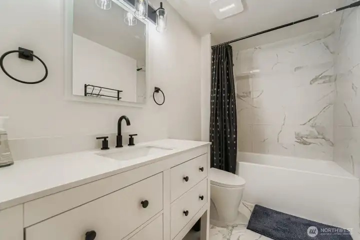 Full bath with tub/shower combo.