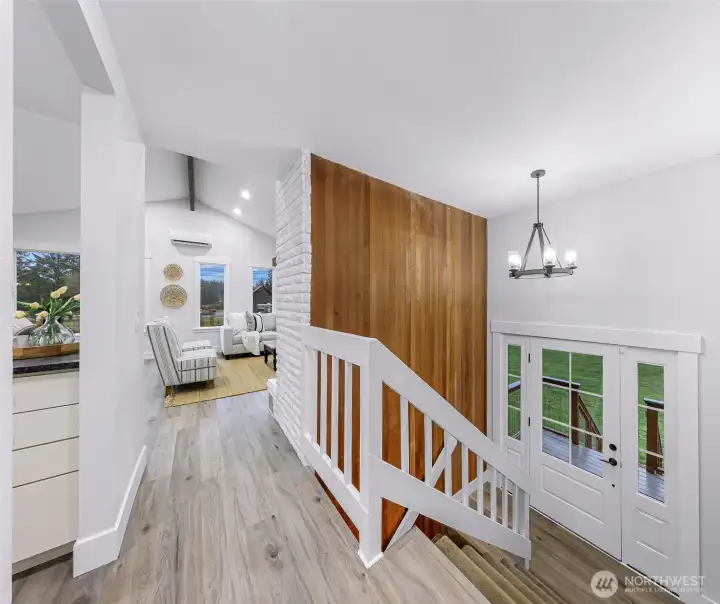 Split level entry with large landing brings you up to the main level living of the home. The wood accent wall bringing warmth into the newly remodeled finished for the rest of the home.