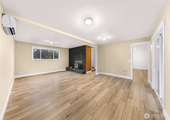 Lower level bonus room! Cozy wood burning fireplace AND has ADU potential for multigenerational living or entertainment. Water hook ups ready to install kitchette