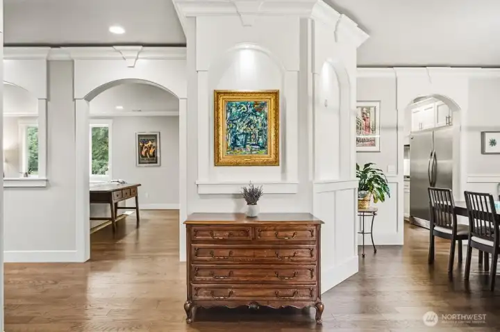 Refined entry way/foyer. Notice all the custom millwork and keystone pediment detailing over the doors.