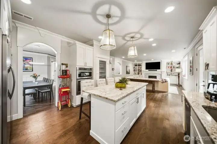 The heart of any home-the kitchen! Slab granite countertops and custom cabinetry, richly hued LVP flooring.