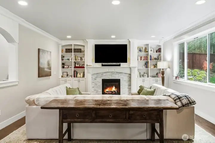 Inviting living room with stone accented gas fireplace.