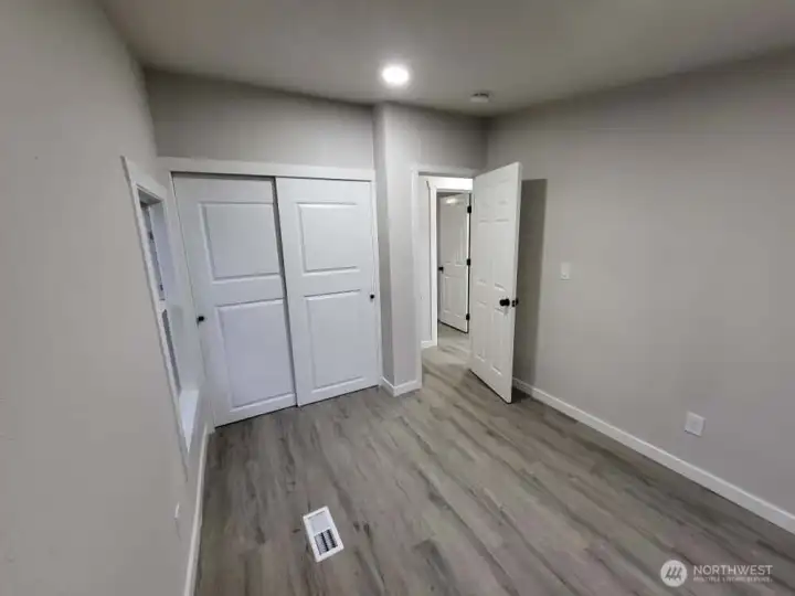 As promised; view from the corner between the 2 windows, showing off the closet in bedroom #3, featuring quiet, sliding doors and a super high ceiling inside! This is the last photo for now (12/23). More to come soon! Check back or come see it yourself!