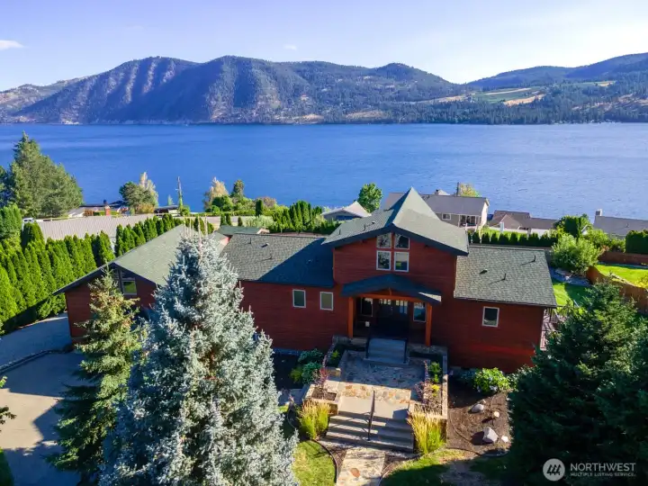 Aerial view of home and carriage house w/ landscaped grounds overlooking Lake Chelan.