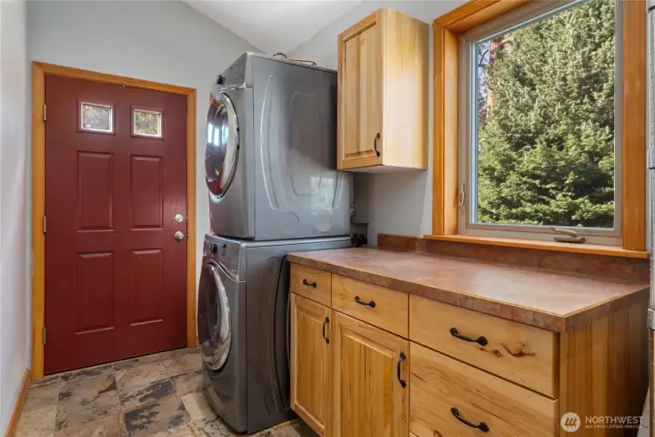 View of main level utility room just off the kitchen. The door leads to the outdoor living area and also features a large adjacent pantry.