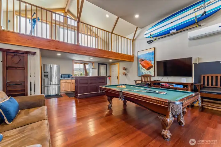 Detached carriage house w/ game area, kitchenette, bathroom and upper balcony exercise area.