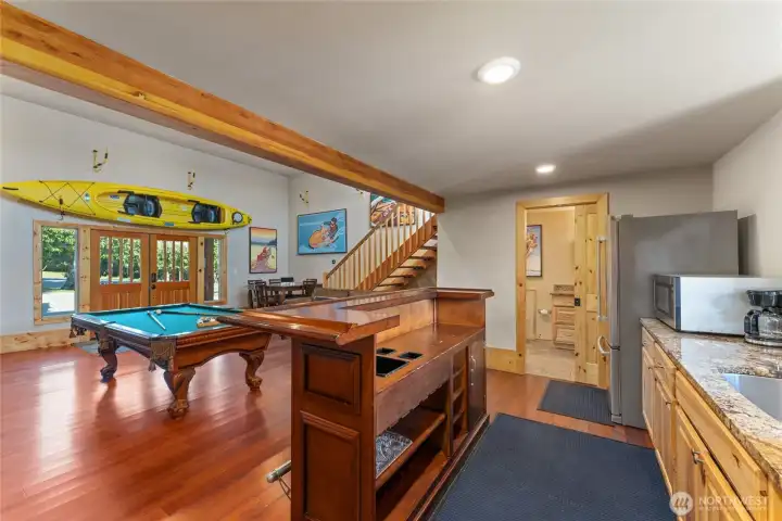 Detached carriage house w/ game area, kitchenette, bathroom plus upper balcony exercise area.