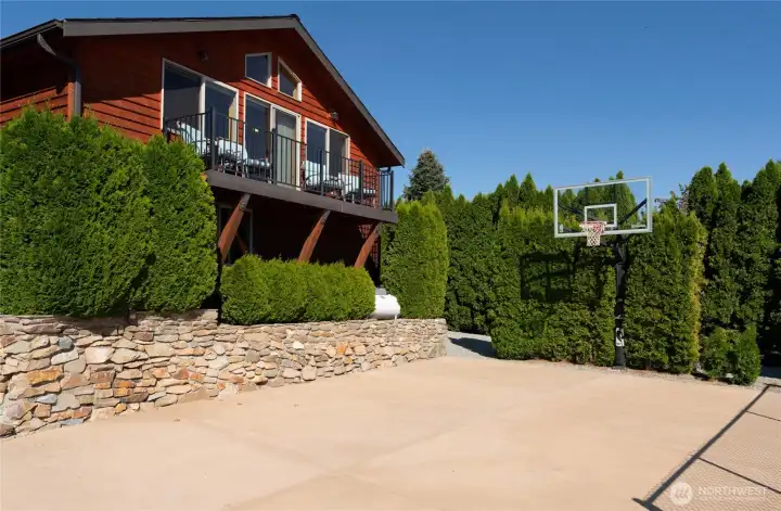 View of detached carriage house w/ view deck and private basketball court.