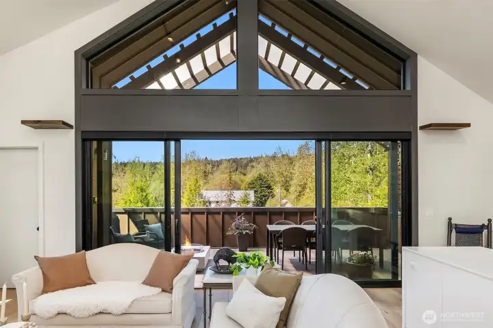 The upper floor living space with soaring ceilings and open space