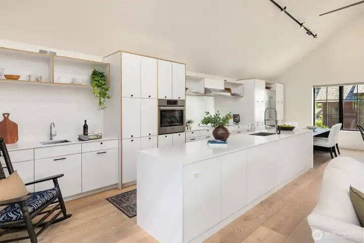 The kitchen stretches the entire wall and includes wet bar, fantastic appliance package and large island.