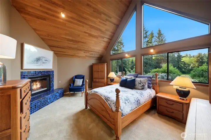 Wake up to garden views through grand picture windows. The primary bedroom has a gas fireplace, walk-in closet and tons of storage.