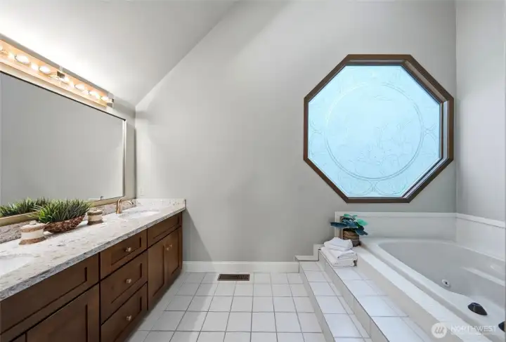 Double sinks, a jetted soaking tub and steam shower make the primary bathroom a true spa experience.