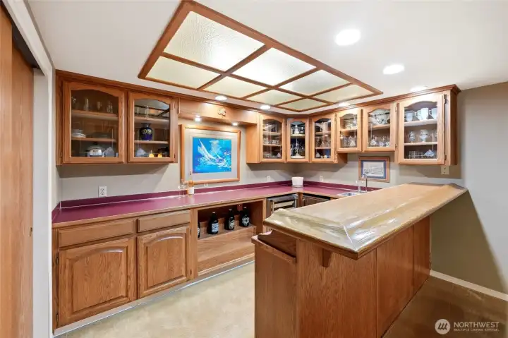 Wet bar / kitchenette has a sink, mini-fridge and beverage fridge.