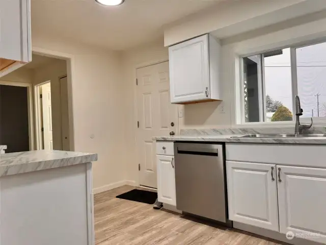 The kitchen leads to 2 bedrooms, 2nd bath, and laundry room.