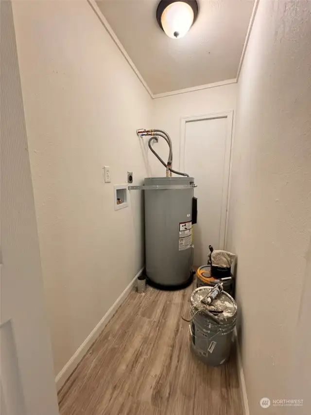 Utility room for stackable  washer/dryer and new water heater.