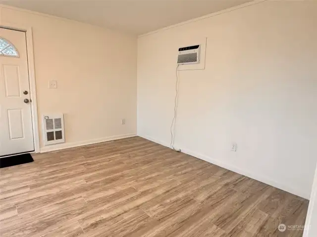 Opposite side of the large living room with new heater and air conditioner.