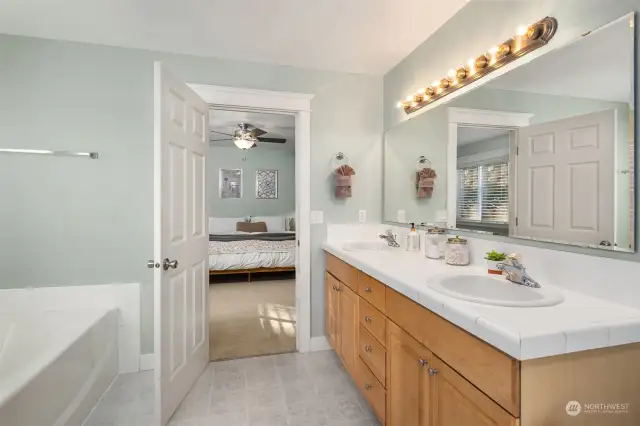 Primary bath features a dual sink vanity, soaking tub, and separate shower.