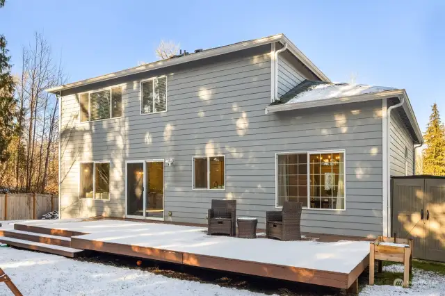 Back exterior with an expansive deck, perfect for relaxing or entertaining.