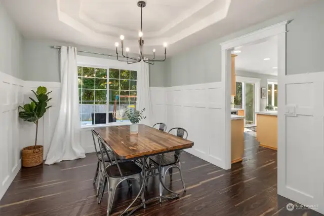 The elegant formal dining room, accented with wainscoting and a tray ceiling, is an ideal setting for intimate gatherings.