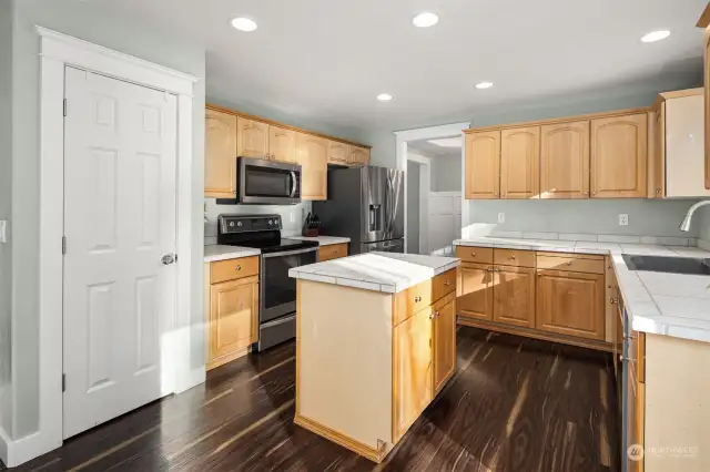 The spacious kitchen is a cook's delight with a center island and stainless appliances.