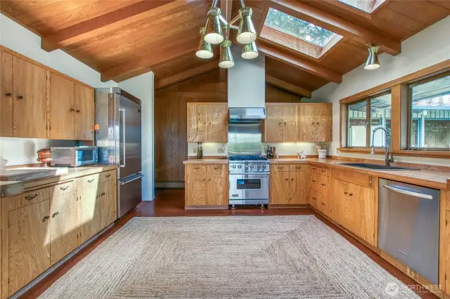 The large kitchen has room for an island. Viking refrigerator and range.