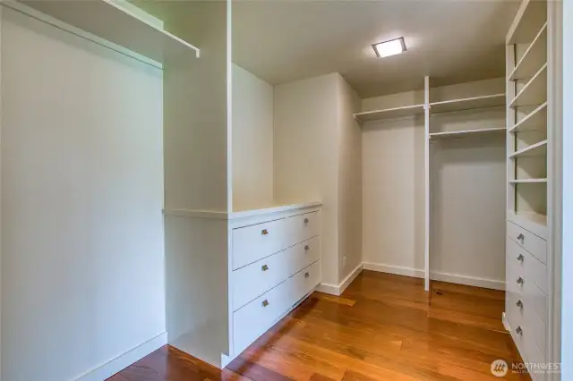 The primary walk-through closet is freshly remodeled in with midcentury elements matching the style of the home.