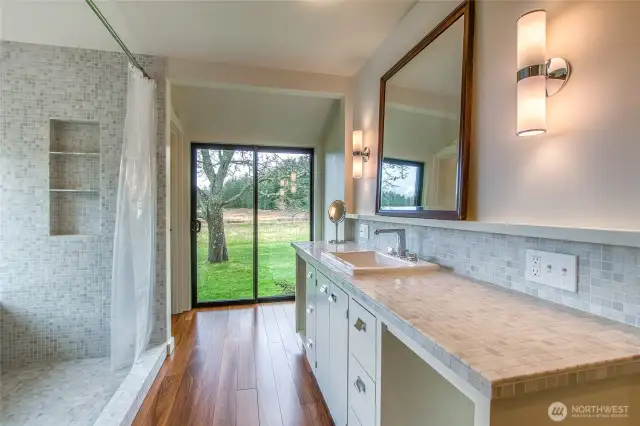 A freshly remodeled primary bathroom brings you into the present with elegant marble finishes, a heated floor, and a bidet toilet.