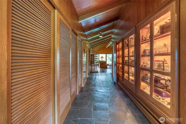 The hallway leading to the Primary suite has ample storage room in the closet and a lighted display cabinet to display fine collectables.